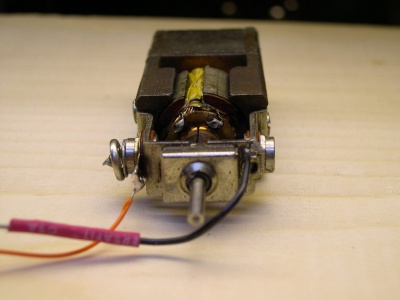The motor has the negative tab soldered to the motor frame, which completes the electrical circuit with the locomotive frame.